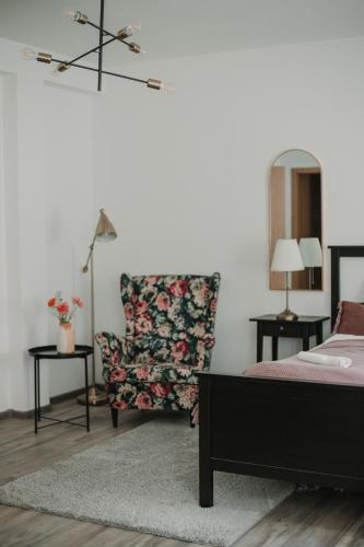 a bedroom with a bed and a chair at Gallery Apartment 3 in Martin