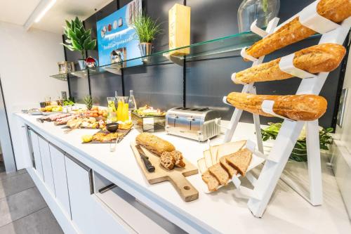 a bakery counter with bread and sandwiches on it at Novotel Toulouse Centre Wilson in Toulouse