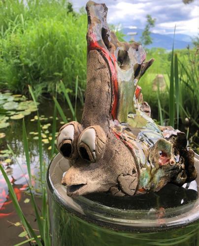 a statue of a dog in a bowl of water at Apartments Krista in Seeboden