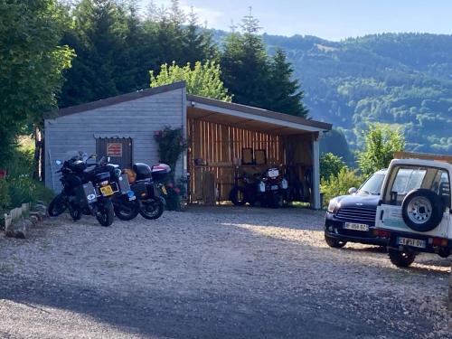 a group of motorcycles parked in front of a garage at la source d'en haut in Valcivières