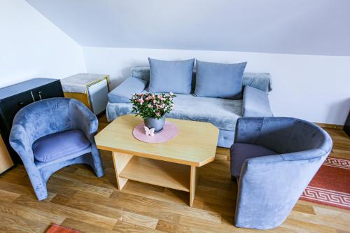 a living room with a couch and two chairs and a table at Villa Nadmorska Łeba Centrum in Łeba