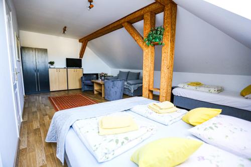 a bedroom with two beds and a living room at Villa Nadmorska Łeba Centrum in Łeba