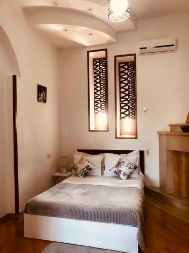 a bedroom with a bed with two pillows on it at Hotel Tamar Mepe in Kutaisi