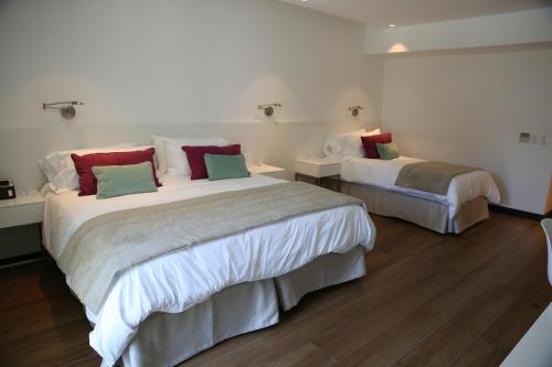 Una cama o camas en una habitación de Ilum Experience Home