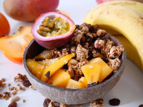 a small bowl of granola with apples and a banana at Hôtel Influences La Bresse in La Bresse