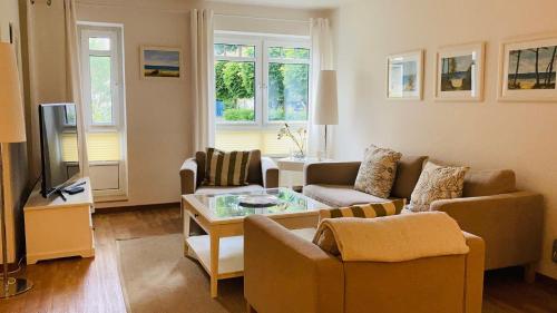 a living room with a couch and a table at FEWO II Villa Nicole Hafenstraße 37 in Zingst