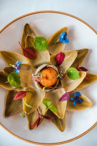 a plate of food with a flower design on it at Novotel Toulouse Centre Wilson in Toulouse