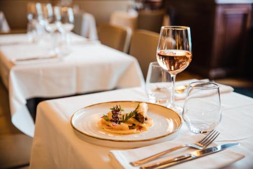 a plate of food on a table with a glass of wine at Novotel Toulouse Centre Wilson in Toulouse
