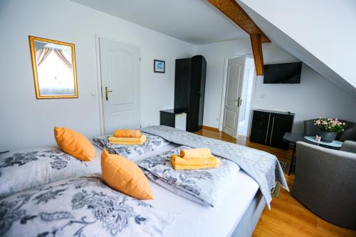 a bedroom with two beds with orange pillows on them at Villa Nadmorska Łeba Centrum in Łeba