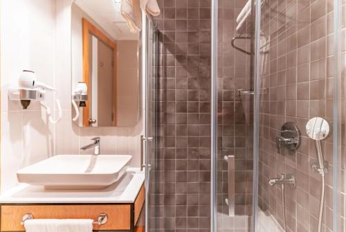 a bathroom with a sink and a shower at PEARLY HOTEL in Antalya