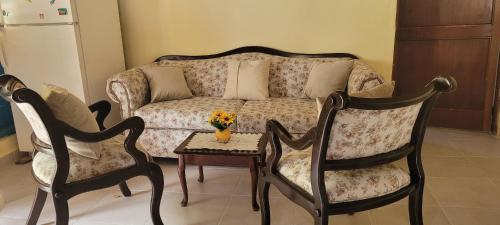 a living room with a couch and two chairs and a table at La Casita de Mary in Santa Cruz de Barahona