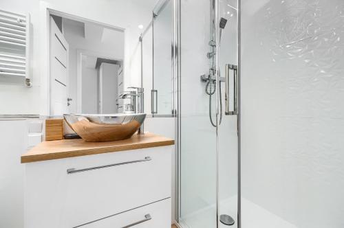 La salle de bains est pourvue d'un lavabo et d'une douche. dans l'établissement Apartament 2000 Stare Miasto Apartamenty No 1, à Szczecin