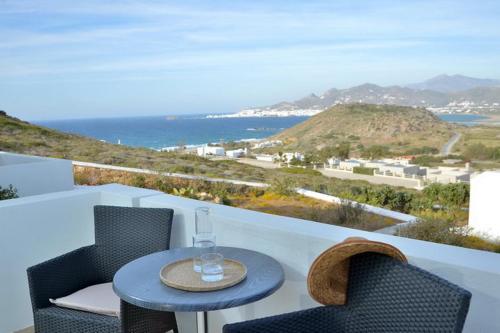 a table and chairs on a balcony with a view of the ocean at Hotel Mediterranean in Stelida