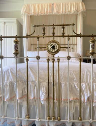 a gold and white bed with a white canopy at The Buckley Arms in Dinas Mawddwy