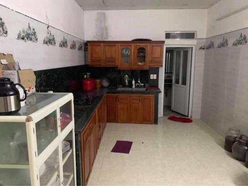a kitchen with wooden cabinets and a refrigerator at Homestay hải tiến 25 in Thanh Hóa