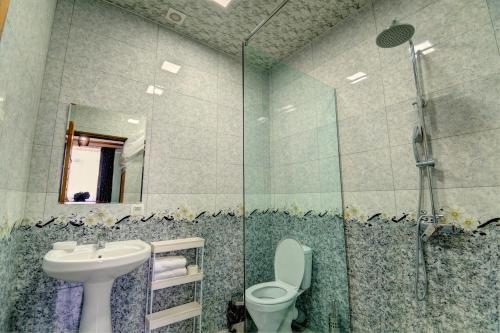 a bathroom with a toilet and a sink and a shower at Hotel SESIL in Gyumri