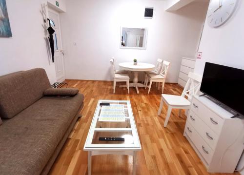 a living room with a couch and a table at Apartment Tatiana in Dubrovnik