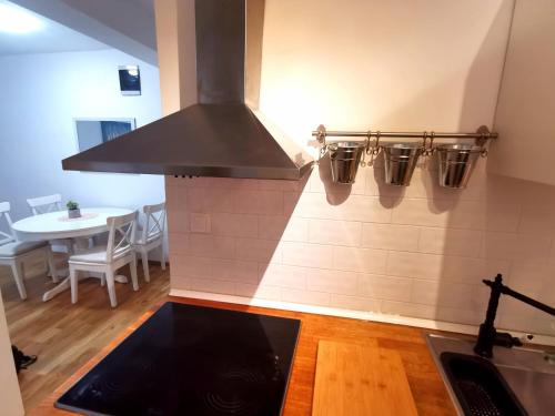 a kitchen with a stove top oven next to a table at Apartment Tatiana in Dubrovnik