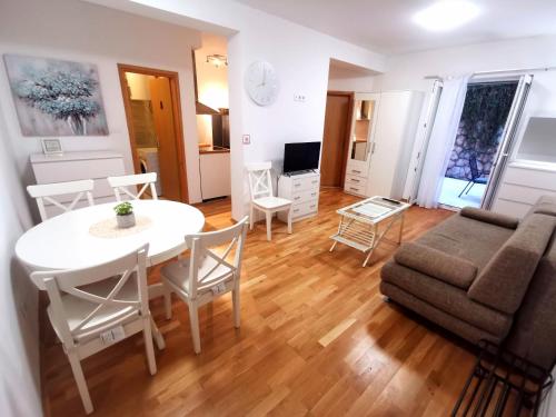 a living room with a table and a couch at Apartment Tatiana in Dubrovnik