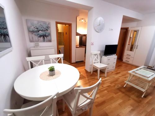 a living room with a white table and chairs at Apartment Tatiana in Dubrovnik