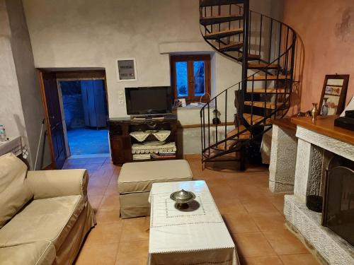 a living room with a couch and a fireplace at Vathia Tower 1894 in Váthia