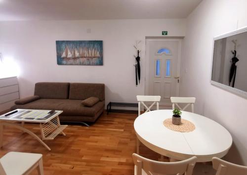 a living room with a table and a couch at Apartment Tatiana in Dubrovnik