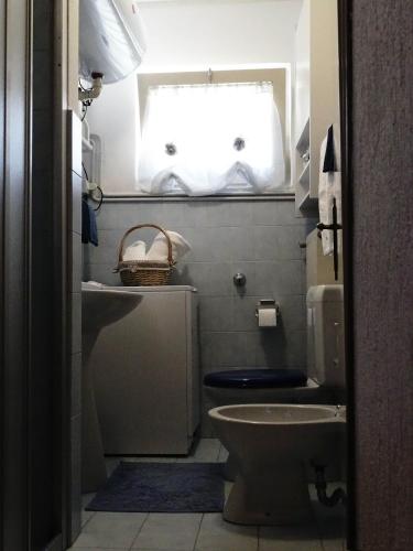 a bathroom with a toilet and a window at La casetta di Elsa in Cesiomaggiore
