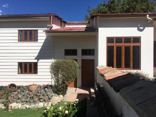 a white house with a fence in front of it at La casa de Teresita in La Paz