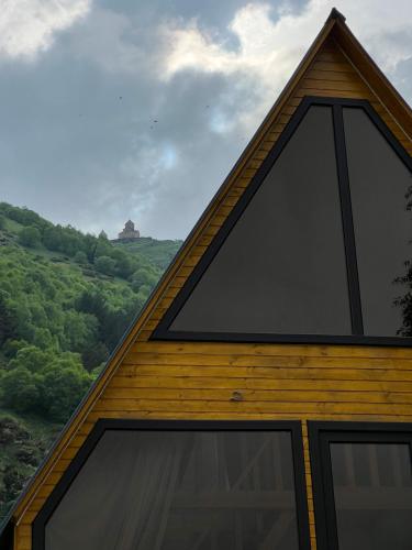a peaked roof of a house with a view at Pine Chalet Kazbegi in Stepantsminda