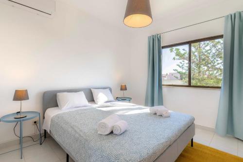 a bedroom with a bed with towels on it at #072 Casa Longa by Home Holidays in Albufeira