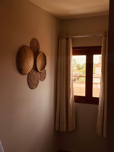 a room with a window and a decoration on the wall at Beach Eco Stays Hotel Boutique Lagoinha in Tigre