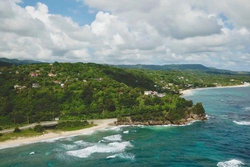 an aerial view of a beach and the ocean at I VIEW - in Long Bay in Long Bay Village
