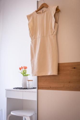 a dress hanging on a wall next to a table at Villa Nesa - beautiful guest house at continental Croatia with Outdoor swimming pool, Sauna and 3 Bedrooms in Plaški