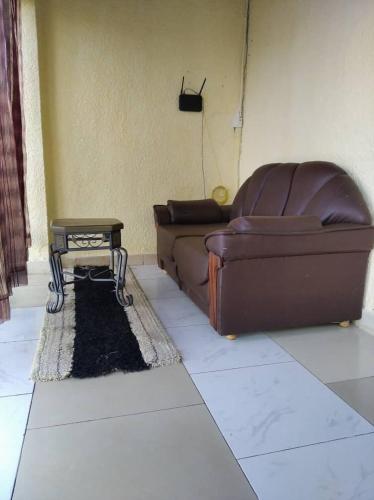 a living room with a couch and a coffee table at Zion INN in Kigali