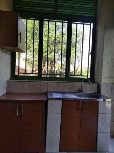 a kitchen with a sink and a window at Zion INN in Kigali