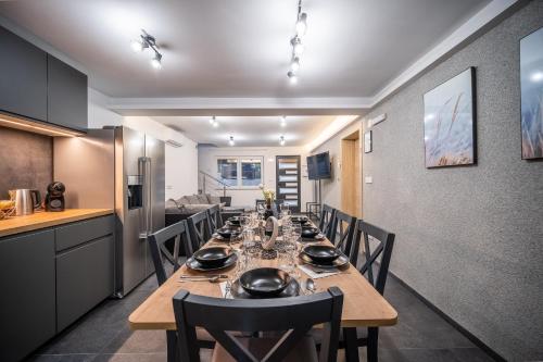 a dining room with a long table and chairs at Villa Nesa - beautiful guest house at continental Croatia with Outdoor swimming pool, Sauna and 3 Bedrooms in Plaški