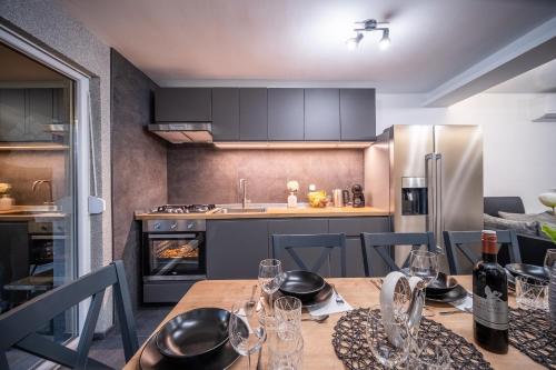 a kitchen with a table with wine glasses on it at Villa Nesa - beautiful guest house at continental Croatia with Outdoor swimming pool, Sauna and 3 Bedrooms in Plaški