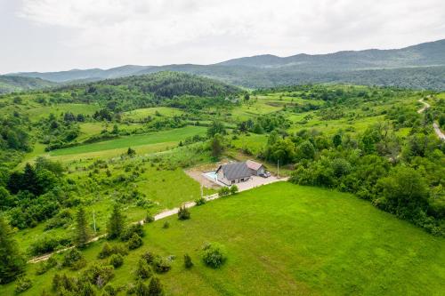 an aerial view of a house in the middle of a green field at Villa Nesa - beautiful guest house at continental Croatia with Outdoor swimming pool, Sauna and 3 Bedrooms in Plaški