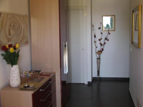 a room with a table and a vase of flowers at Villa Rosa in Modica