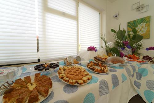 a table topped with pies and other food on it at Hotel Rivabella in Davoli
