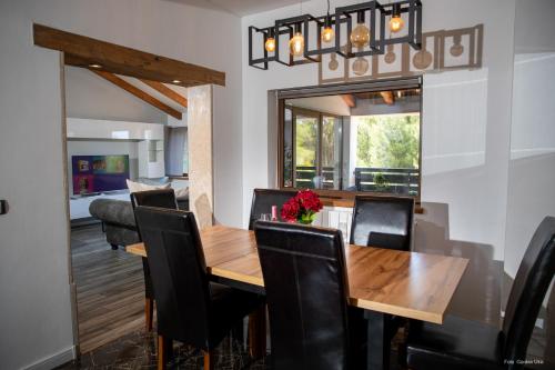 a dining room with a wooden table and black chairs at Apartment "Istra Inspirita" in Rovinj