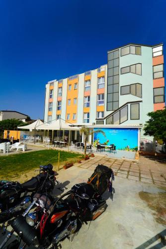 a row of motorcycles parked in front of a building at Hotel Rivabella in Davoli