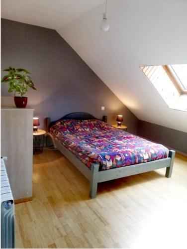 a bedroom with a bed in a attic at La Miellerie du Massegros in Le Massegros