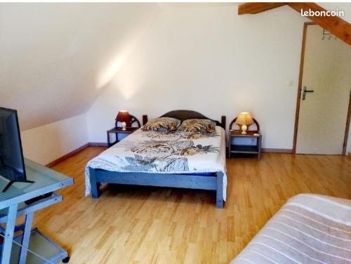 1 dormitorio con 1 cama y 2 mesas con lámparas en La Miellerie du Massegros en Le Massegros