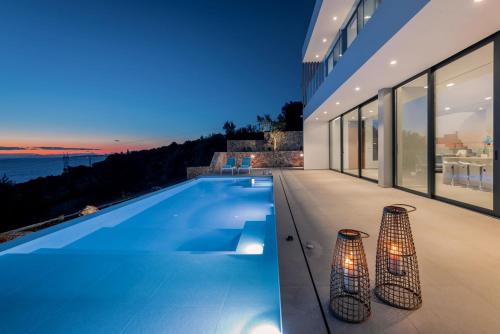 a swimming pool in a house with a view of the ocean at The Sall Villa - Private pool and Breathtaking Views, by ZanteWize in Agios Nikolaos