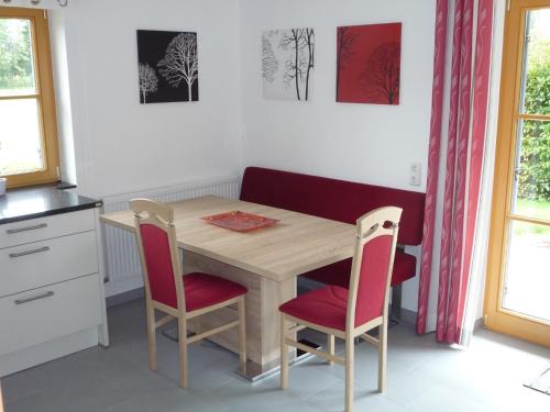 a kitchen with a wooden table and two chairs at Ferienwohnung Aletsee in Pfronten