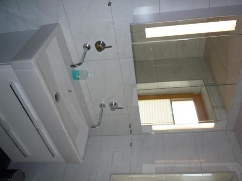 a bathroom with a shower with a window and a sink at Ferienwohnung Aletsee in Pfronten