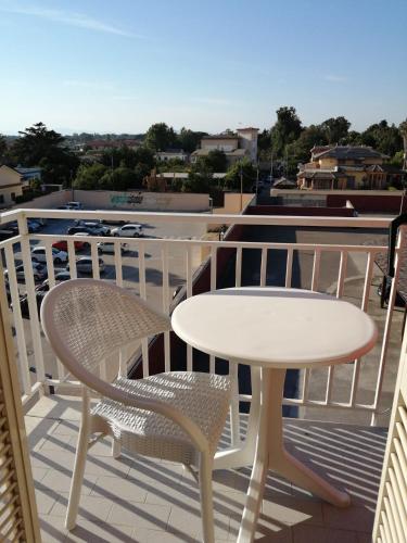a white table and chairs on a balcony at Hotel Tiffany in Varcaturo