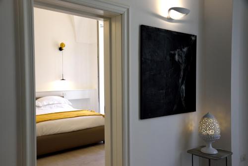 a bedroom with a bed and a door with a mirror at Li Frati Suite in Lecce