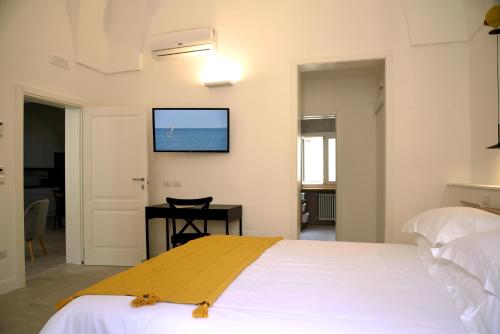 a bedroom with a bed and a television on the wall at Li Frati Suite in Lecce